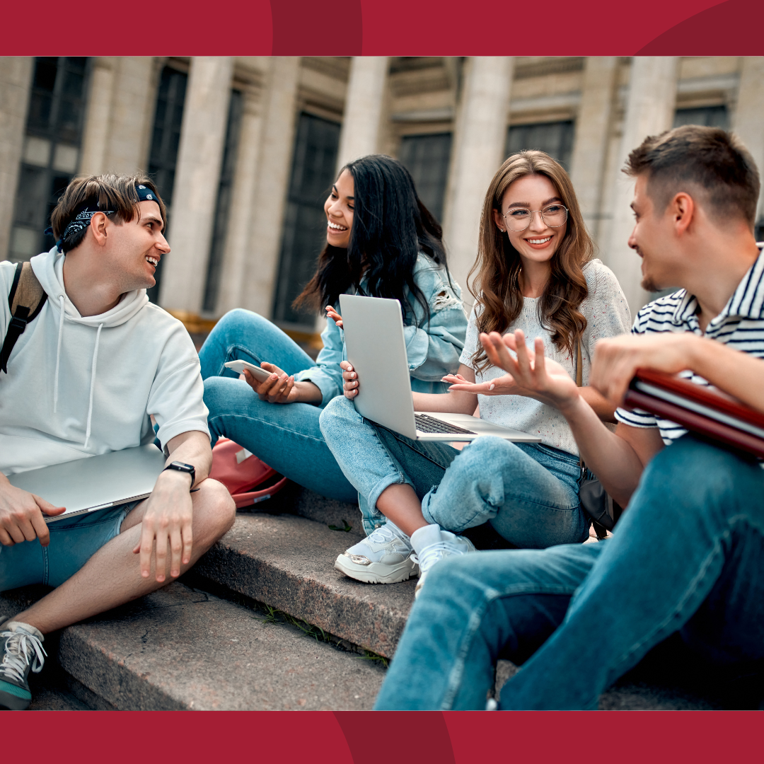 Group of college students sitting on steps and talking. 